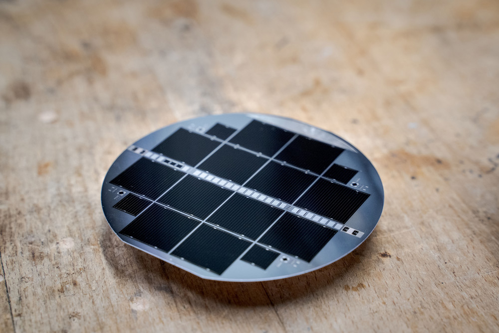 Several III-V tandem solar cells on a 10cm-diameter silicon substrate. 