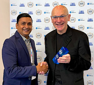POET's Raju Kankipati accepts the ECOC Award from Optica board member Michael Lebby.